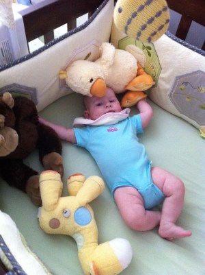 Sophia and friends Hanging out in her crib with her giraffe, monkey and duckie