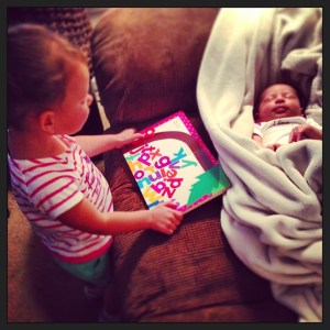Sophia reading to Maddie while Maddie sleeps.